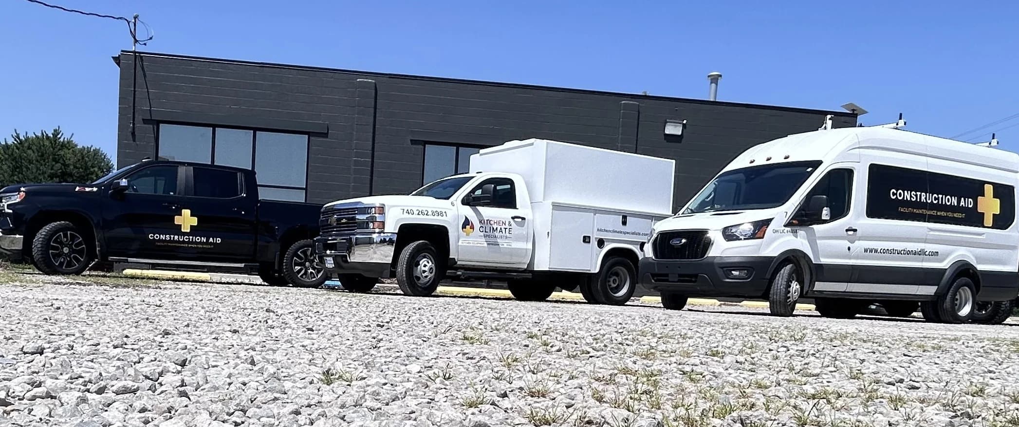 Kitchen & Climate Specialists service trucks staged outside the shop