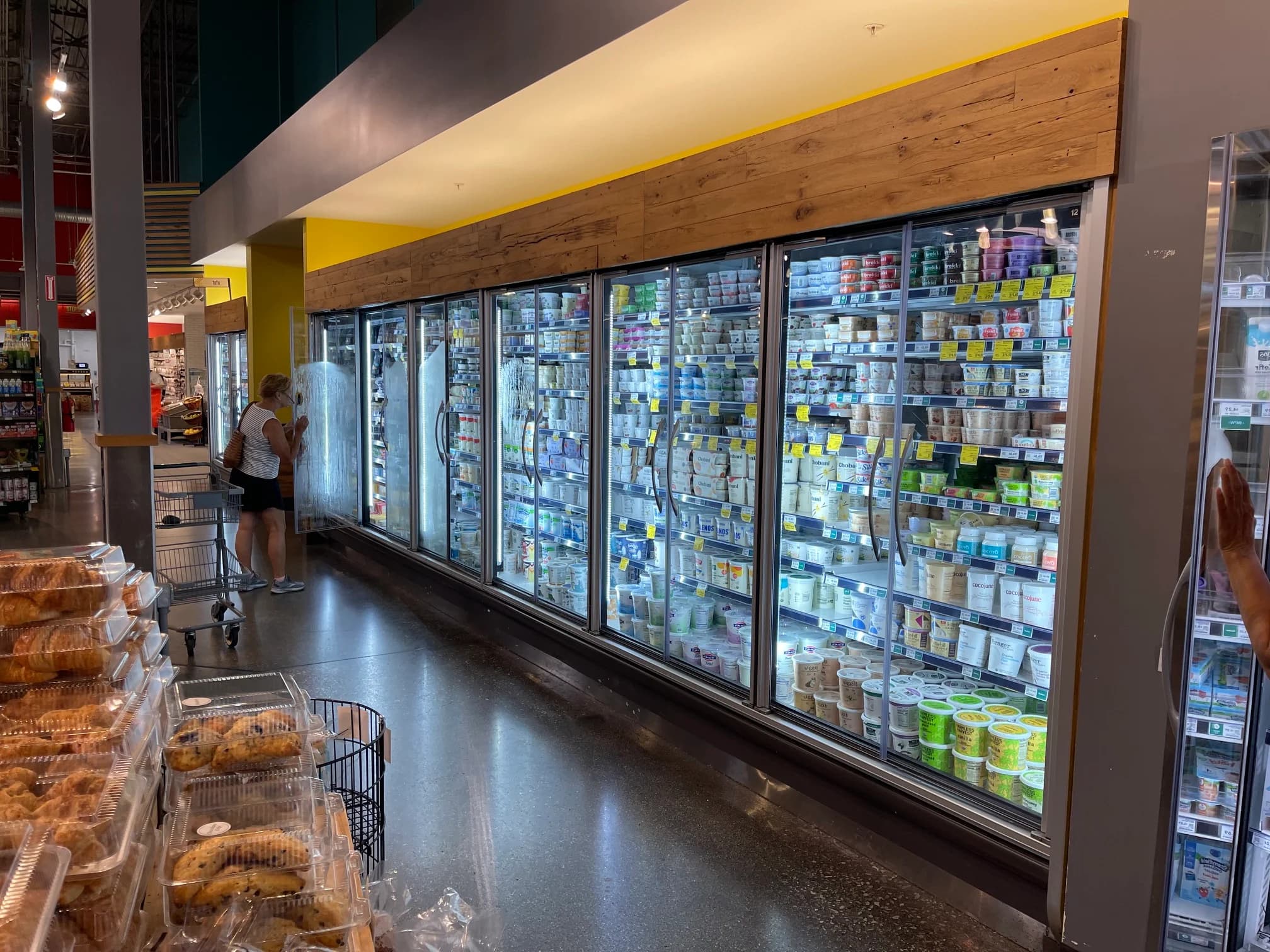 Glass-door refrigerated cases serviced in a retail cooler aisle