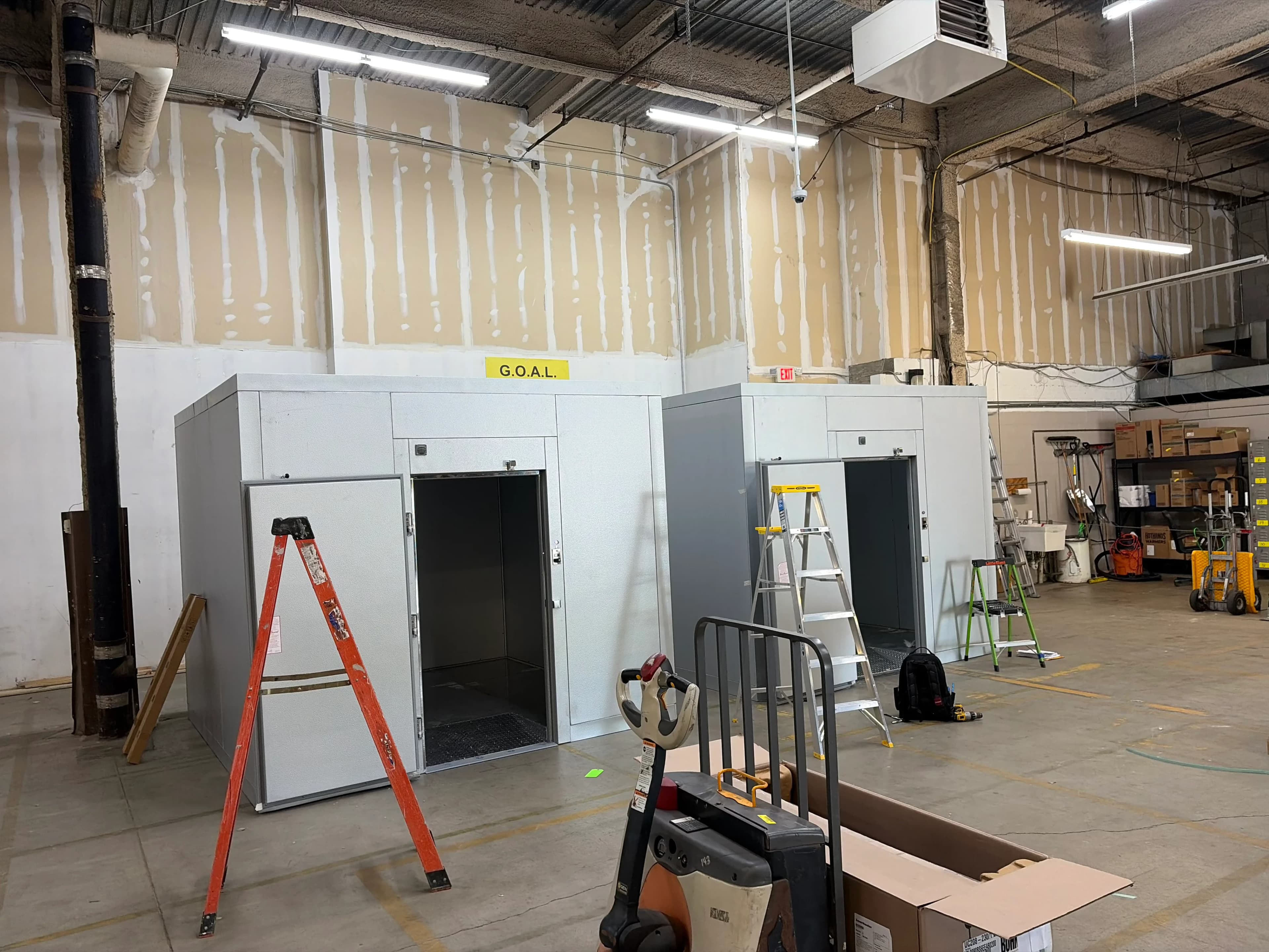 New walk-in cooler boxes under construction in a distribution facility