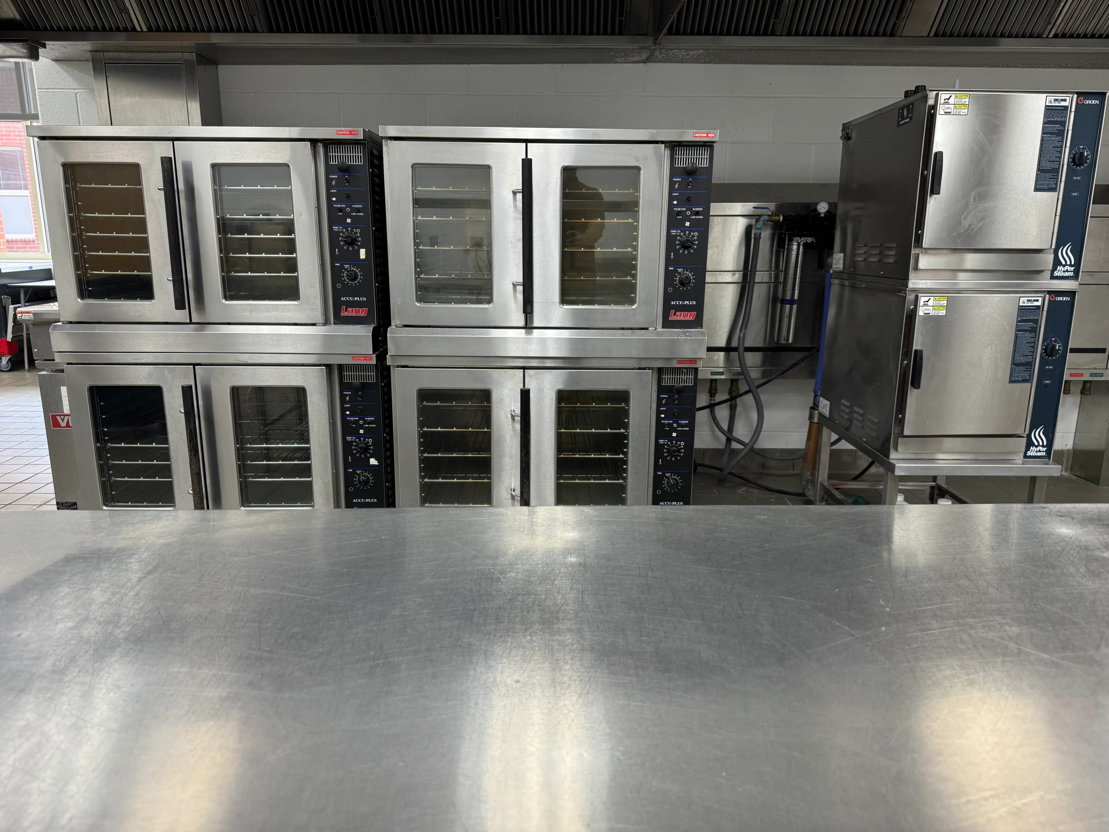 A row of stacked commercial convection ovens kept in service